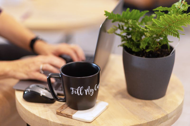 Working at a lap top with coffee cup